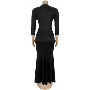 Detail view of the sleek back cut and fitted waist on this elegant black maxi dress