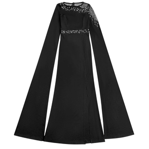 Detail of black evening gown featuring mesh neckline with sparkling beads and floor-length sleeves