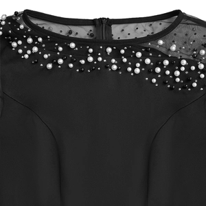 Detail of evening dress neckline with black mesh dots, pearls and beads decoration