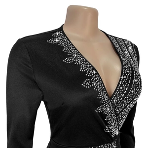 Detail of elegant black V-neck dress featuring sparkling silver rhinestone embellishments