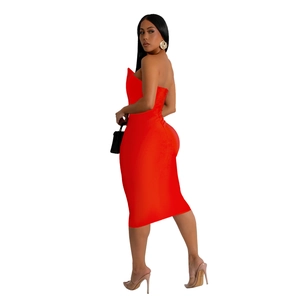 Detail view of a bright red strapless midi dress featuring a bodycon fit and button accents