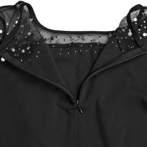 Detailed back view of a black evening dress with mesh panels, pearls, and a hidden zipper