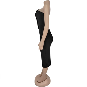 Side view of black strapless midi dress featuring decorative gold buttons and slim fit