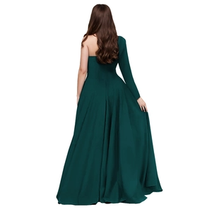 Detail view of the backless design and long sleeve on a dark green velvet evening gown