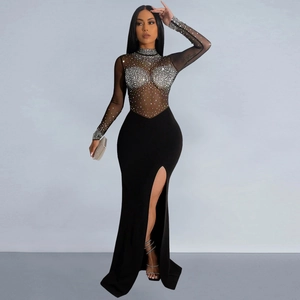 Detail of sheer mesh dress featuring intricate silver rhinestone patterns and side slit