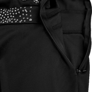 Detail of elegant black dress showing silver rhinestone embellishments and hidden zipper