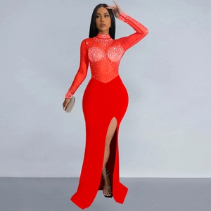 Detail of red floor-length evening dress with sheer mesh, silver rhinestones, and high slit