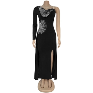 Detailed close-up of a black v-neck dress with silver rhinestones and asymmetric slit