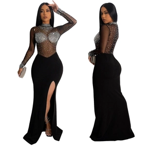 Detail of sheer mesh maxi dress featuring silver rhinestones and a high side slit