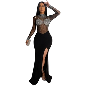 Detail of sheer black mesh dress featuring shimmering silver rhinestones and high side slit