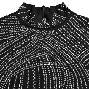 Detail eines schwarzen Rollkragenkleids mit strahlenden Silber-Strasssteinen und Reißverschluss