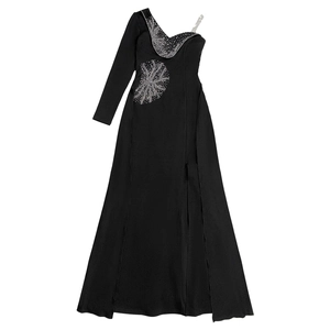 Detail of silver rhinestone fireworks pattern on a black one-shoulder evening dress