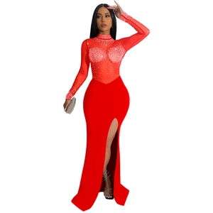 Macro detail of red sheer mesh bodice with rhinestones and high slit evening gown design