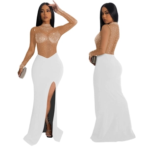 Detail of sheer mesh dress featuring sparkling rhinestones and a high side leg slit
