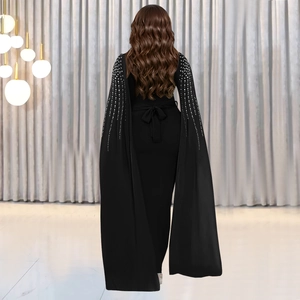 Elegant black evening gown with rhinestone cape sleeves and a bow tie waist detail