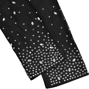 Detail of black mesh fabric with sparkling silver rhinestones and crystal embellishments