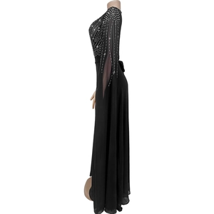 Detail of elegant black evening gown featuring silver rhinestones and sheer slit sleeves