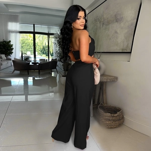 Detail of elegant black two-piece set featuring tube top and high-waist wide-leg pants