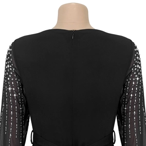 Close-up of the back zip closure and sheer mesh sleeves with sparkling rhinestones