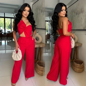Red two-piece set with bow halter crop top and high-waisted wide-leg trousers for women