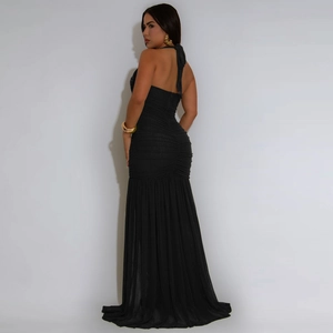 Detail of elegant black backless evening dress with ruching and high slit for formal events
