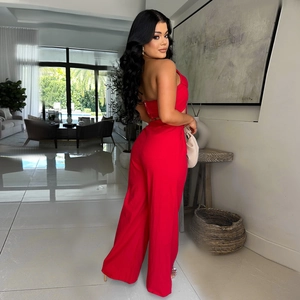 Detail of red two-piece set featuring a slim crop top and high-waisted wide-leg trousers