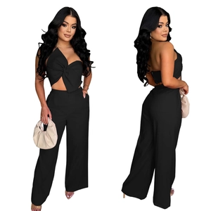 Detail of black bow tube top and high waist wide leg pants two-piece set with woven fabric