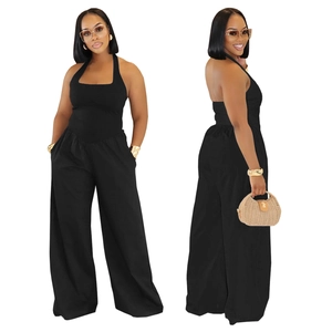 Detail view of black halter neck jumpsuit with high waist wide leg cut and open back style
