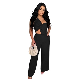 Detail of black two-piece set featuring a strapless bow top and high-waisted wide-leg trousers