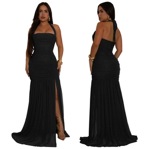 Detail view of a black halter evening dress with ruched fabric and high side slit