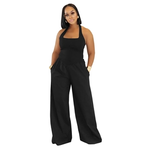 Close-up of black halter neck jumpsuit featuring wide-leg design and ribbed knit fabric