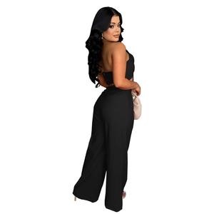 Side view of black backless halter top and matching high-waisted wide-leg trousers