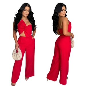 Detail showing red two-piece set with a bow tube top and high-waisted wide-leg trousers