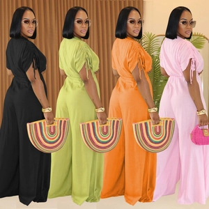 Short sleeve V-neck wide leg jumpsuit with waist tie in black, green, orange and pink