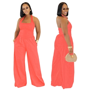 Detail view of coral orange halter wide-leg jumpsuit with backless cut and side pockets
