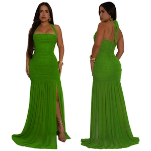 Detail of bright green halter dress featuring ruched bodice and high side slit