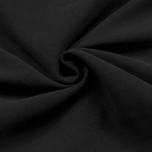 Detail shot of black chiffon fabric texture with elegant whirlpool folds and rhinestone finish