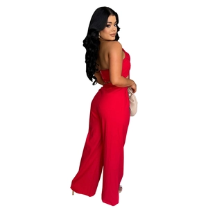 Detail of red halter backless top and high-waisted wide-leg pants fashion set for women