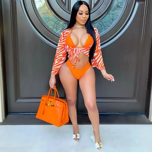 Chic three-piece bikini set with zebra print cardigan and bold orange swimwear detail