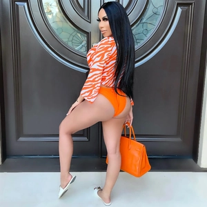 Detailed side view of orange zebra print long sleeve cover-up and bikini set for women