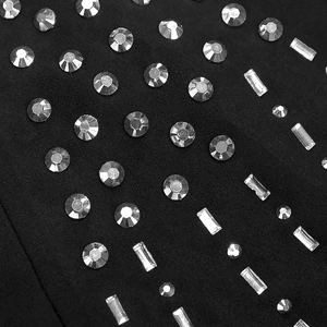 Macro shot of silver rhinestones in round and rectangular cuts on black dress fabric