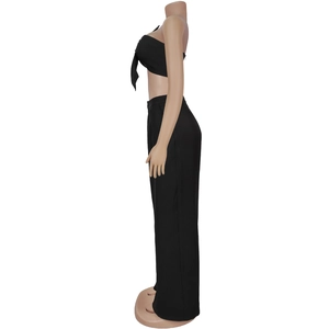 Detail of black strapless tube top with bow tie and high waist wide leg pants