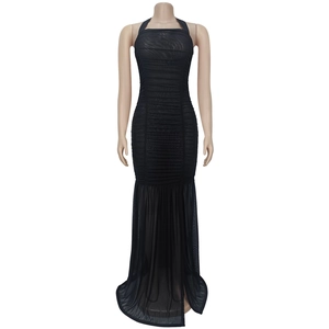 Detailed view of black halter dress with ruched bodice and sheer mesh skirt detail