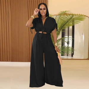Detail view of black V-neck jumpsuit featuring waist cutout and elegant tie-up drawstring