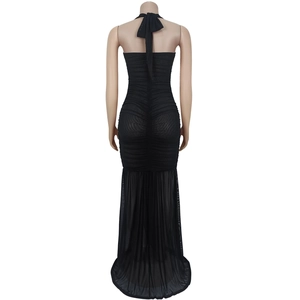 Detail of black mesh ruched dress showing the halter neck tie and sheer fabric textures