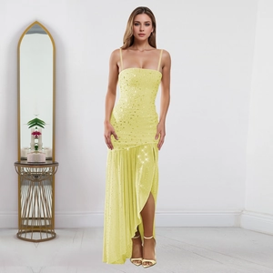Detailed view of yellow sequined dress with high side slit and pleated texture