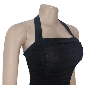 Detail of black halter neck mesh top featuring elegant ruched texture and sheer fabric