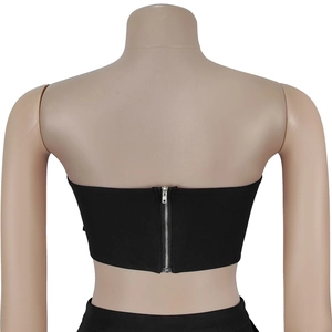 Close-up of the back detail on black tube top featuring a silver metallic zipper closure