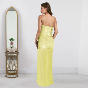 Close-up of bright yellow evening dress featuring a sequined bodice and slit tulle skirt
