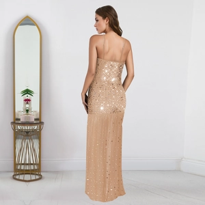 Close-up of champagne sequin dress with intricate silver beadwork and side slit detail